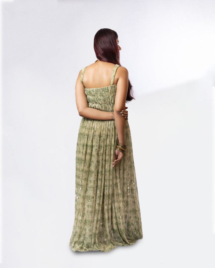Woman wearing a green patterned dress on a white background