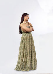 Woman wearing a green patterned dress on a white background