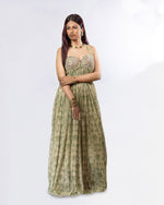 Load image into Gallery viewer, Woman wearing a green patterned dress on a white background
